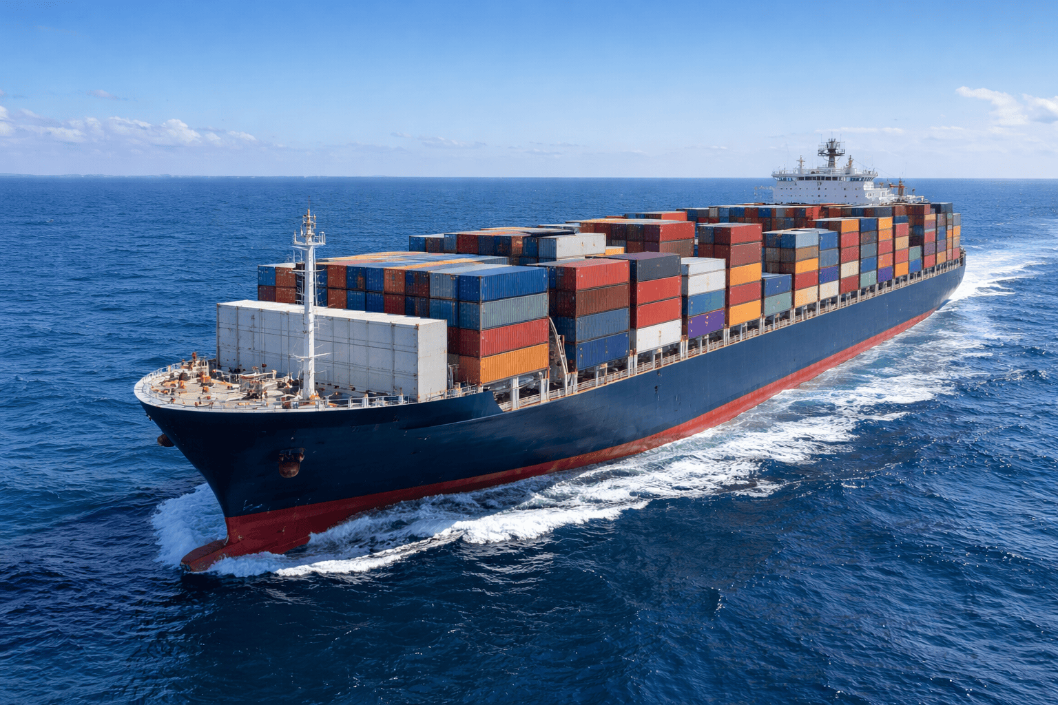large ocean cargo container ship loaded with colorful shipping containers sailing across Pacific Ocean